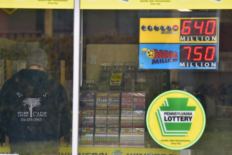 A lottery customer purchases lottery tickets at Conjelko&#039;s Dairy Store in Windber, Pa., as the Mega Millions grew to $750 million and the PowerBall to $ 640 Million on Thursday, Jan. 14, 2021.