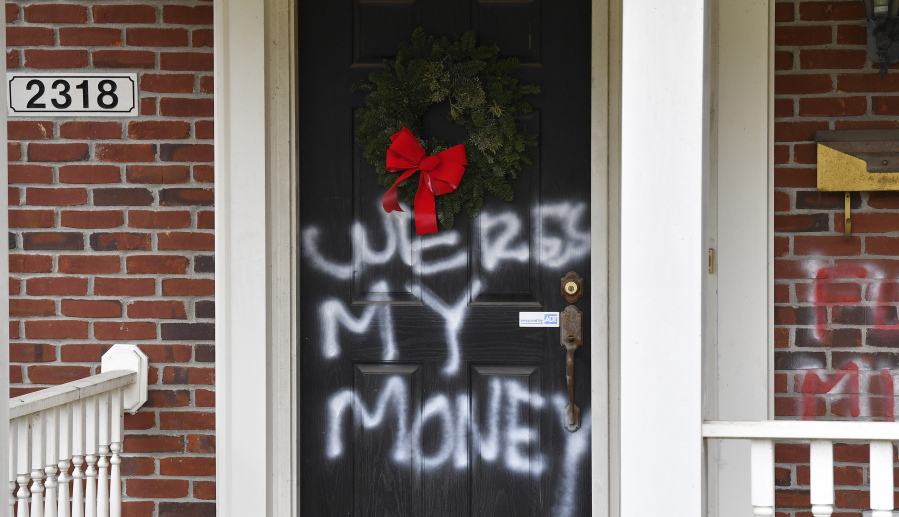 Graffiti reading, &quot;Where&#039;s my money&quot; is seen on a door of the home of Senate Majority Leader Mitch McConnell, R-Ky., in Louisville, Ky., on Saturday, Jan. 2, 2021. As of Saturday morning, messages like &quot;where&#039;s my money&quot; and other expletives were written with spray paint across the front door and bricks of the Kentucky Republican&#039;s Highlands residence.    (AP Photo/Timothy D.