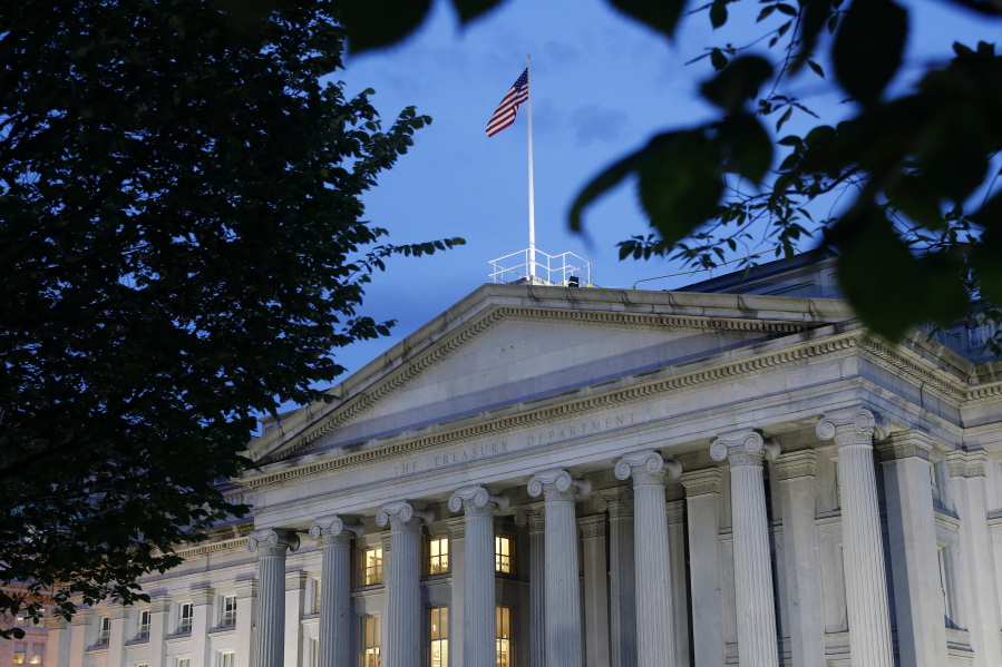 FILE - This Thursday, June 6, 2019 file photo shows the U.S. Treasury Department building at dusk in Washington. The Corporate Transparency Act, enacted into law on Jan. 1, 2021, seeks to strengthen controls by creating a registry managed by the Treasury Department that will contain the names of the true owners of both domestically-created shell companies as well as foreign ones conducting business in the U.S.
