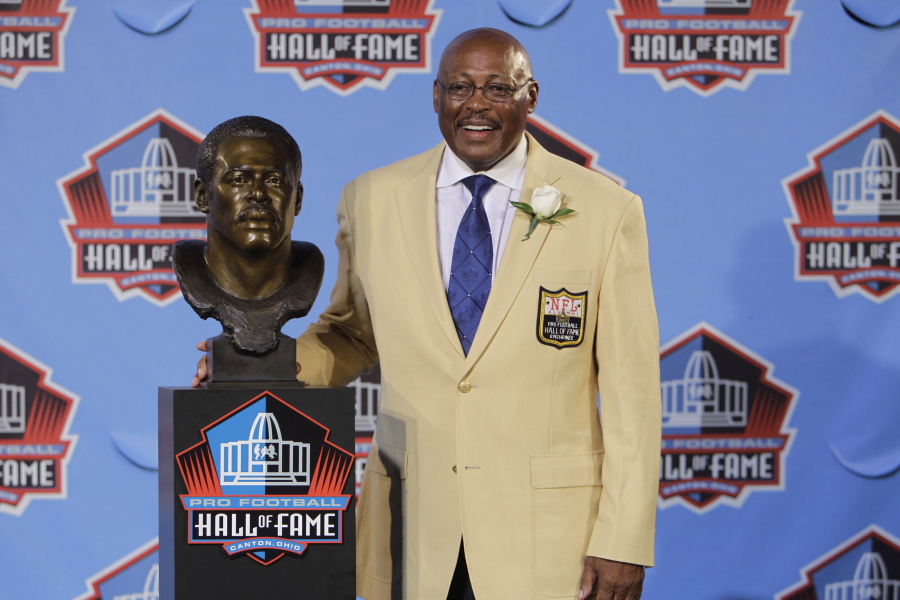 Floyd Little poses with his bust after enshrinement in the Pro Football Hall of Fame in 2010 at Canton, Ohio. Little, the Hall of Fame running back who starred at Syracuse and for the Denver Broncos, has died at age 78. The Pro Football Hall of Fame said he died Friday, Jan. 1, 2021.