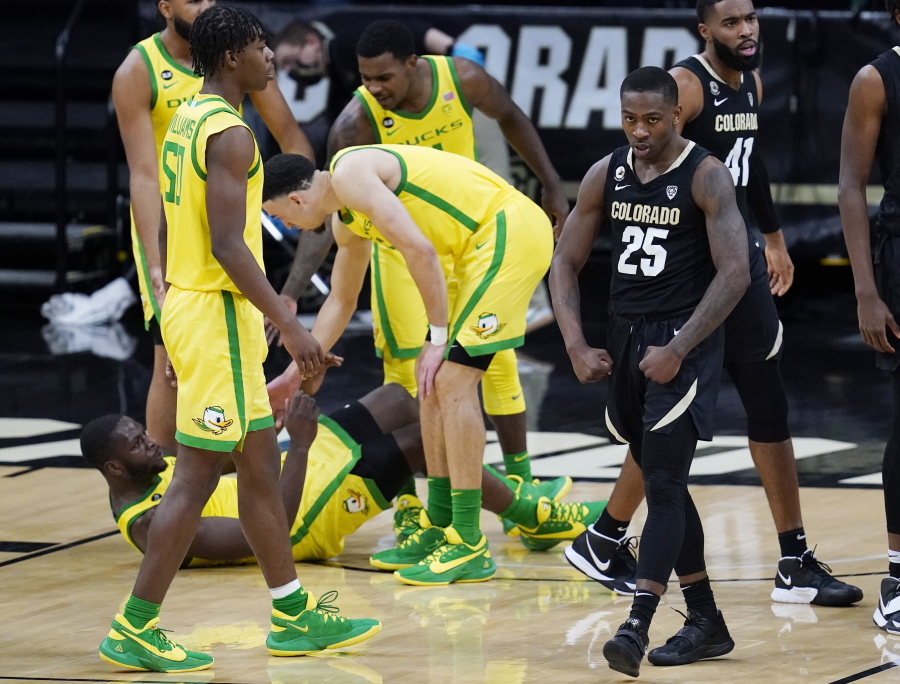 Colorado guard McKinley Wright IV, right, flexes after drawing a foul against Oregon during the second half of an NCAA college basketball game Thursday, Jan. 7, 2021, in Boulder, Colo. Colorado won 79-72.