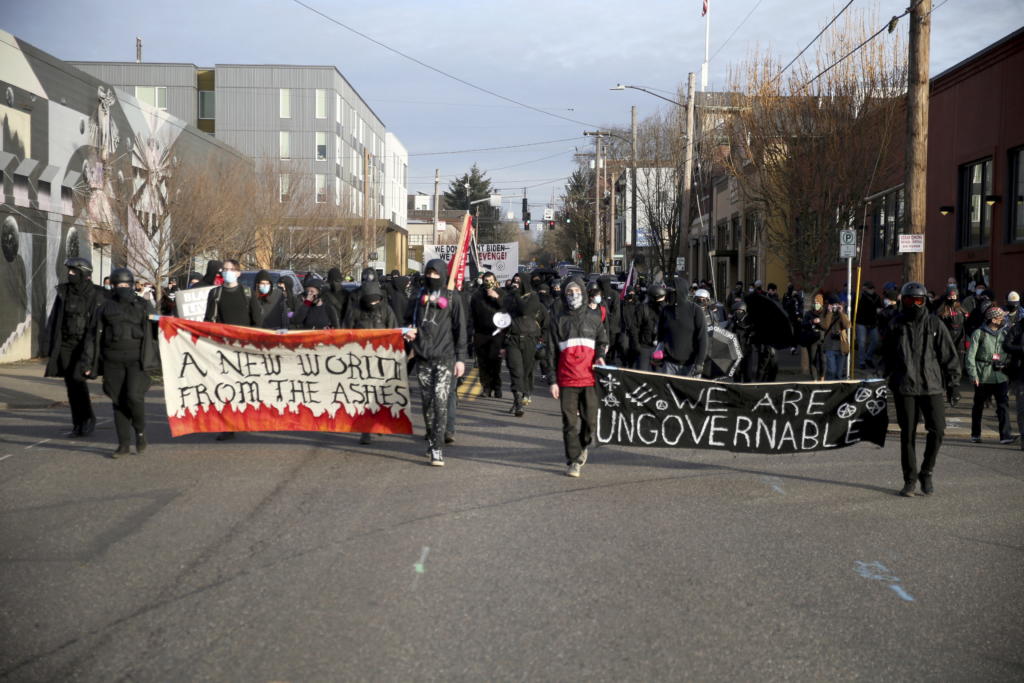 Demonstrators march during a protest on Inauguration Day in Southeast Portland, Ore.