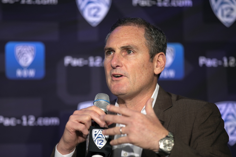 FILE - In this Oct. 7, 2019, file photo, Pac-12 Commissioner Larry Scott speaks to reporters during the Pac-12 Conference women&#039;s NCAA college basketball media day in San Francisco. Scott is stepping down at the end of June 2021, ending an 11-year tenure in which the conference landed a transformational billion dollar television deal but struggled to keep up with some of its Power Five peers when it came to revenue and exposure. (AP Photo/D.