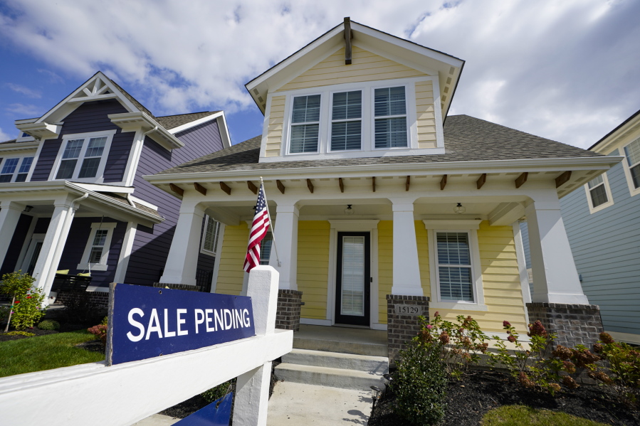 A &quot;sale pending&quot; sign is posted on.a home in Westfield, Ind., Friday, Sept. 25, 2020. Sales of new homes remained steady in October at a seasonally adjusted rate of 999,000 units. While the Commerce Department said October new home sales were down 0.3% from September, the government revised up its September figure marginally.
