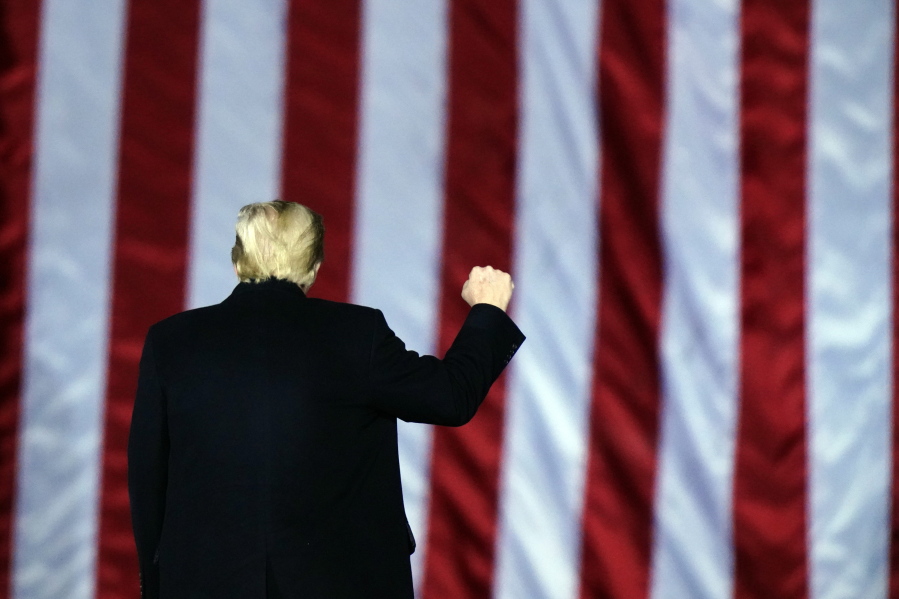 President Donald Trump gestures at a campaign rally in support of U.S. Senate candidates Sen. Kelly Loeffler, R-Ga., and David Perdue in Dalton, Ga., Monday, Jan. 4, 2021.