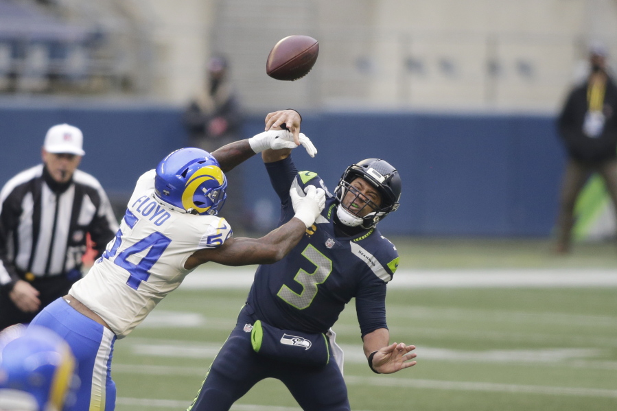 Los Angeles Rams outside linebacker Leonard Floyd (54) knocks the ball away as Seattle Seahawks quarterback Russell Wilson tries to pass during the first half of an NFL wild-card playoff football game, Saturday, Jan. 9, 2021, in Seattle.