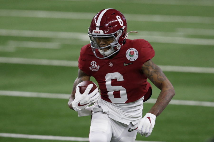 Alabama wide receiver DeVonta Smith (6) gains yardage after a catch in the first half of the Rose Bowl NCAA college football game against Notre Dame in Arlington, Texas, Friday, Jan. 1, 2021.