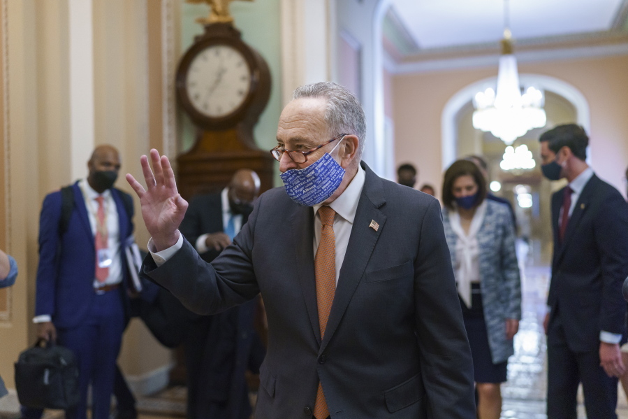 On the first full day of Democratic control, Senate Majority Leader Chuck Schumer, D-N.Y., walks to the chamber after meeting with new senators from his caucus, at the Capitol in Washington, Thursday, Jan. 21, 2021. (AP Photo/J.