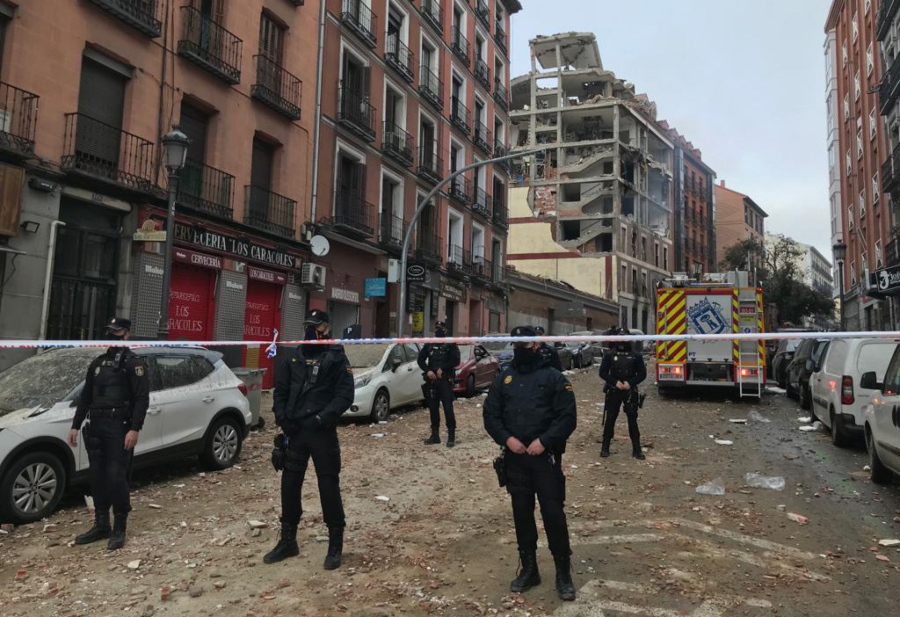 Police officers cordon off Toledo Street following an explosion in downtown Madrid, Spain, Wednesday, Jan. 20, 2021. A loud explosion of unknown origin has partially destroyed a six-floor-tall building flanked by a school and a nursing home in the center of Spain&#039;s capital, Madrid.