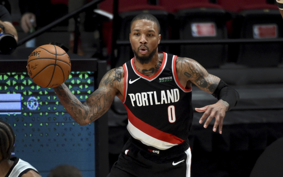 Portland Trail Blazers guard Damian Lillard passes the ball during the second half of an NBA basketball game against the San Antonio Spurs in Portland, Ore., Monday, Jan. 18, 2021. The Spurs won 125-104.