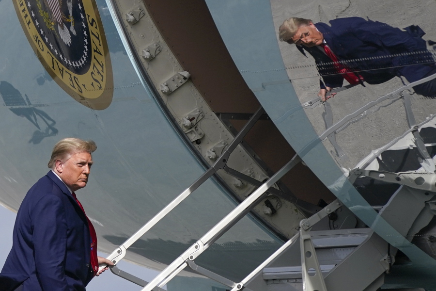 President Donald Trump boards Air Force One at Palm Beach International Airport, Thursday, Dec. 31, 2020, in West Palm Beach, Fla. Trump is returning to Washington after visiting his Mar-a-Lago resort.