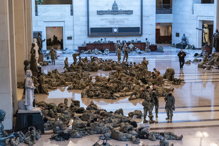 Hundreds of National Guard troops hold inside the Capitol Visitor&#039;s Center to reinforce security at the Capitol in Washington, Wednesday, Jan. 13, 2021. The House of Representatives is pursuing an article of impeachment against President Donald Trump for his role in inciting an angry mob to storm the Capitol last week. (AP Photo/J.