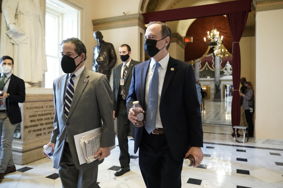 Rep. Jamie Raskin, D-Md., left, walks with Rep. Adam Schiff, D-Calif., at the Capitol in Washington, Wednesday, Jan. 13, 2021, as the House of Representatives pursues an article of impeachment against President Donald Trump for his role in inciting an angry mob to storm the Capitol last week. (AP Photo/J.