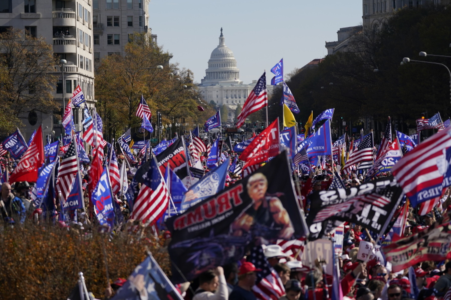 FILE - In this Nov. 14, 2020, file photo with the U.S. Capitol in the background, supporters of President Donald Trump rally at Freedom Plaza in Washington.