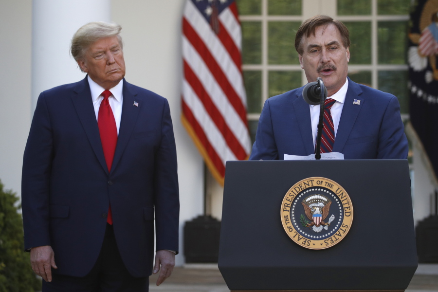 FILE - In this March 30, 2020, file photo, My Pillow CEO Mike Lindell speaks as President Donald Trump listens during a briefing about the coronavirus in the Rose Garden of the White House, in Washington. Twitter has permanently banned Lindell&#039;s Twitter account after he continually perpetuated the baseless claim that Donald Trump won the 2020 U.S. presidential election.