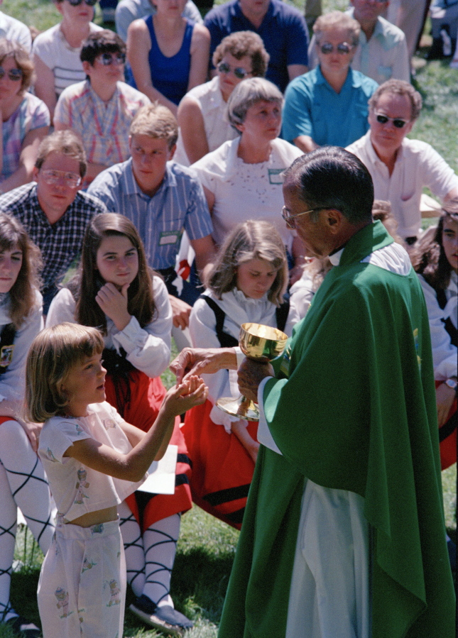 FILE - In this Spet. 19, 1988 file photo Rev. Joseph Hart dispenses communion during an outdoor Mass celebrated for participants of the Basque Festival in Buffalo, Wyo. On Tuesday, Jan. 26, 2020 the Vatican&#039;s Congregation for the Doctrine of the Faith cleared retired Cheyenne, Wyoming Bishop Hart of seven accusations of abuse, determined that five others couldn&#039;t be proven &quot;with moral certitude&quot; and that two cases involving boys, who were 16 and 17, couldn&#039;t be prosecuted given the Catholic Church didn&#039;t consider them minors at the time of the alleged abuse, the diocese said.