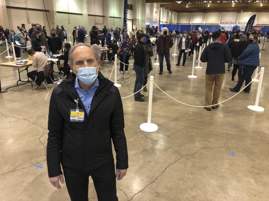 Dr. Ralph Yates, chief medical officer for Salem Health Hospital and regional care system, stands Friday at the Oregon State Fairgrounds in Salem, Ore., where hospital personnel are giving COVID-19 vaccinations to health care workers. The National Guard will assist in the coming days.