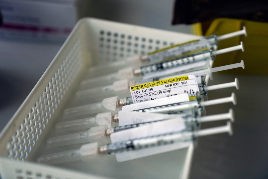 Syringes containing the Pfizer-BioNTech COVID-19 vaccine sit in a tray in a vaccination room at St. Joseph Hospital in Orange, Calif., Thursday, Jan. 7, 2021. (AP Photo/Jae C.