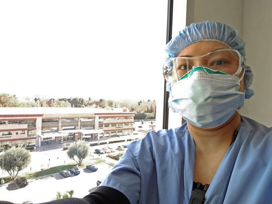 Nurse Nerissa Black takes a selfie wearing protective gear at work on Dec. 13, 2020 at Henry Mayo Newhall Hospital in Valencia, Calif. Black was already having a hard time tending to four COVID-19 patients who need constant heart monitoring. But because of staffing shortages affecting hospitals throughout California, her workload recently increased to six people infected with the coronavirus. Overwhelmed California nurses are now caring for more COVID-19 patients after the state began issuing waivers that allow hospitals to temporarily bypass strict nurse-to-patient ratios. Nurses say the new workload is pushing them to the brink of burnout and affecting patient care.