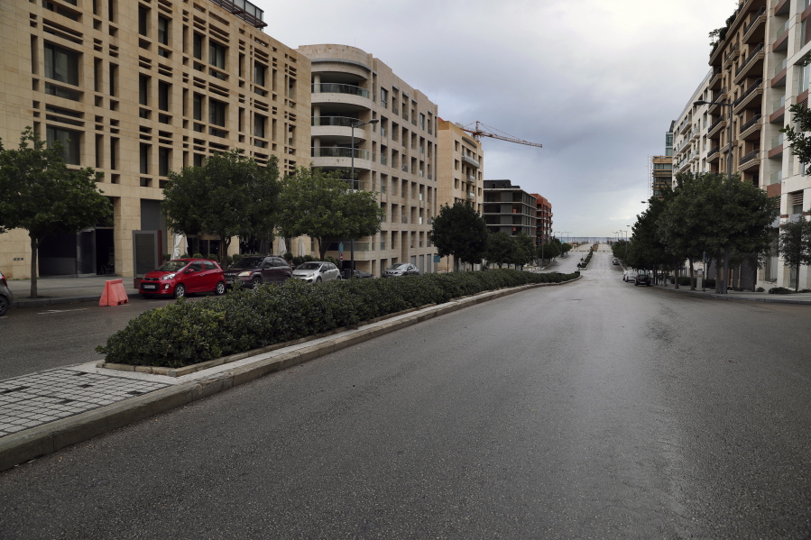 A street is empty of cars during a lockdown aimed at curbing the spread of the coronavirus, in Beirut, Lebanon, Thursday, Jan. 14, 2021. Lebanese authorities began enforcing an 11-day nationwide shutdown and round the clock curfew Thursday, hoping to limit the spread of coronavirus infections spinning out of control after the holiday period.