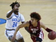 UCLA forward Jalen Hill (24) defends against Washington State guard Isaac Bonton (10) during the first quarter of an NCAA college basketball game Thursday, Jan. 14, 2021, in Los Angeles.