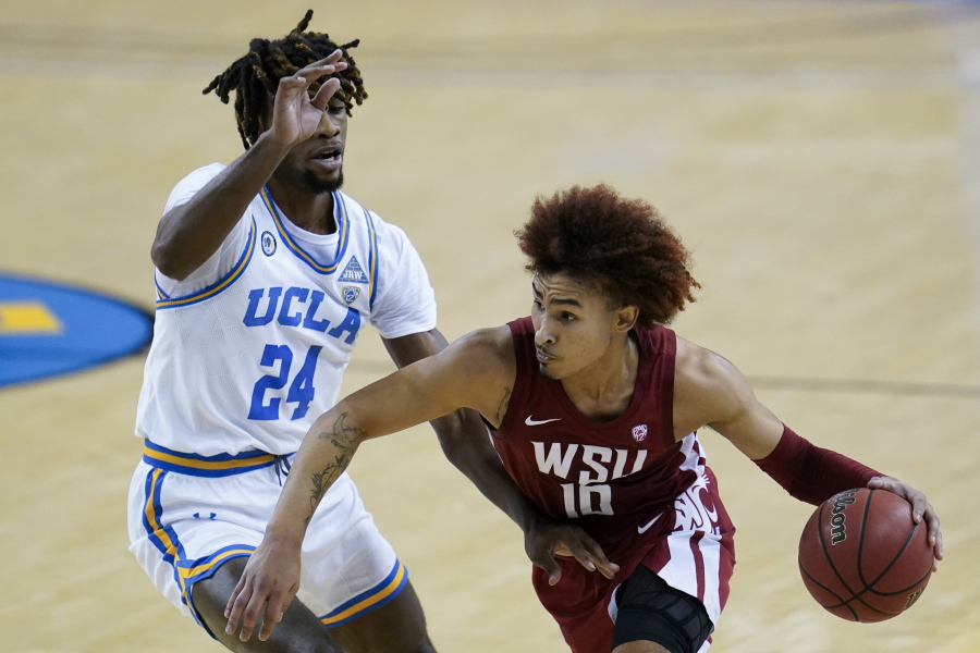 UCLA forward Jalen Hill (24) defends against Washington State guard Isaac Bonton (10) during the first quarter of an NCAA college basketball game Thursday, Jan. 14, 2021, in Los Angeles.