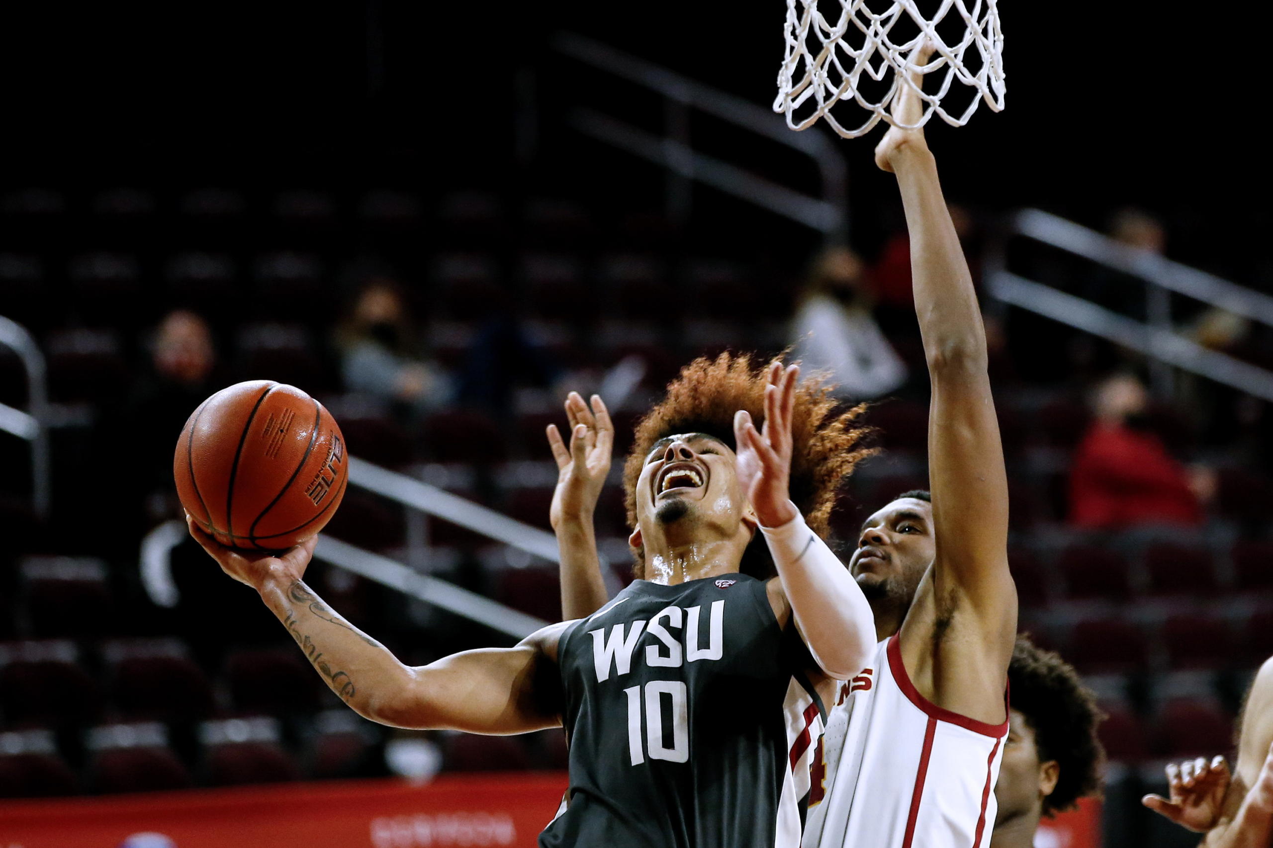 Washington State guard Isaac Bonton (10) goes up to basket under pressure from Southern California forward Evan Mobley (4) during the second half of an NCAA college basketball game Saturday, Jan. 16, 2021, in Los Angeles. (AP Photo/Ringo H.W.