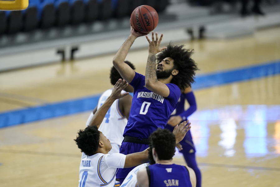 Washington guard Marcus Tsohonis (0) takes a shot against UCLA guard Jaylen Clark (0) during the first half of an NCAA college basketball game Saturday, Jan. 16, 2021, in Los Angeles.