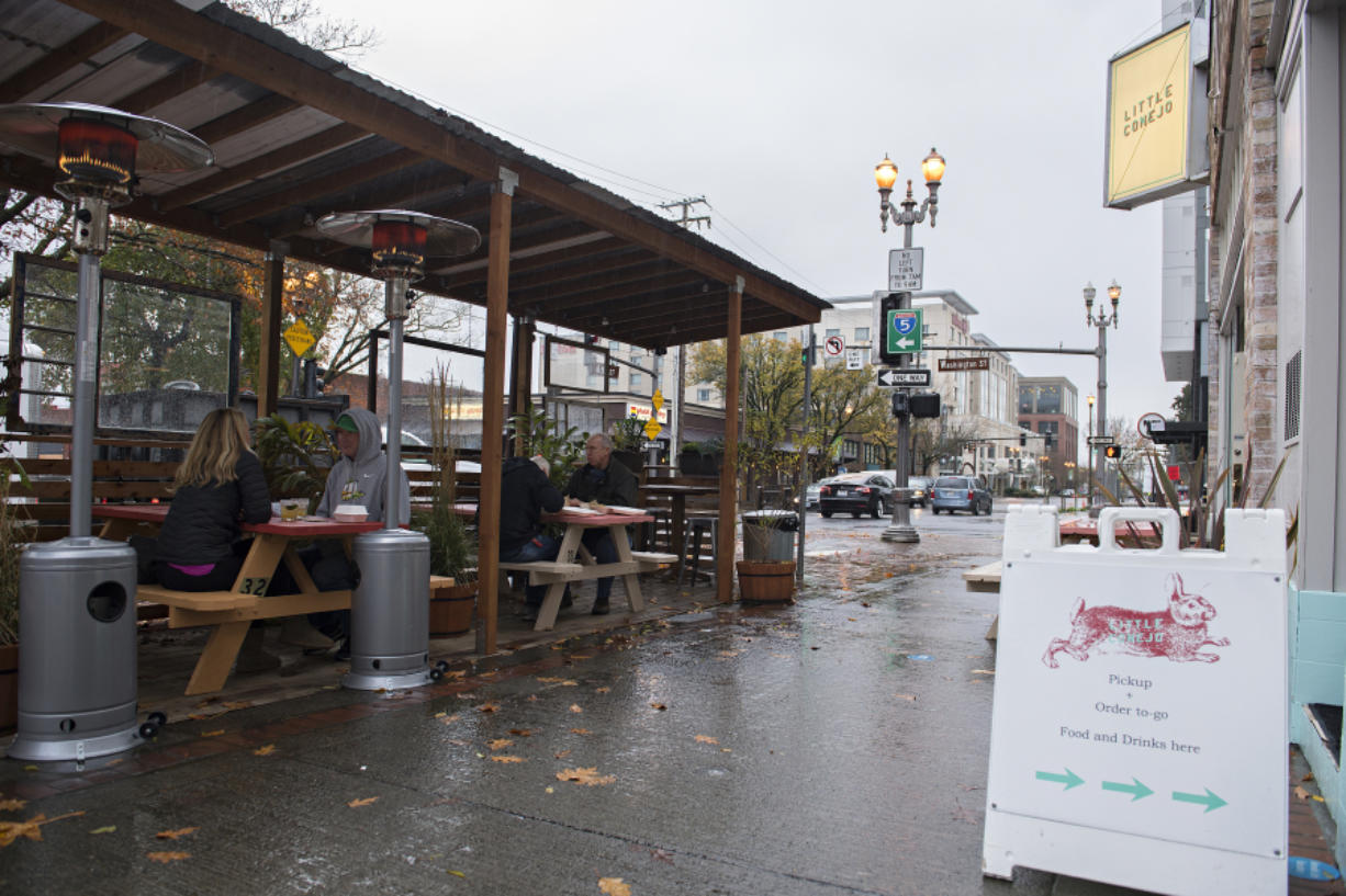Customers stay dry in the outdoor dining area of Little Conejo on Sixth Street in downtown Vancouver.