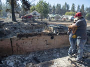 Shawn Thornton hugs his wife, Shannon Thornton, next to the rubble of their burned home Tuesday, Sept. 8, 2020, in Malden, Washington the day after a fast-moving wildfire swept through the tiny town west of Rosalia. Shawn and Shannon weren&#039;t home at the time, but their son Cody was and managed to get their dog and a few belongings before leaving just minutes before the flames swept through.