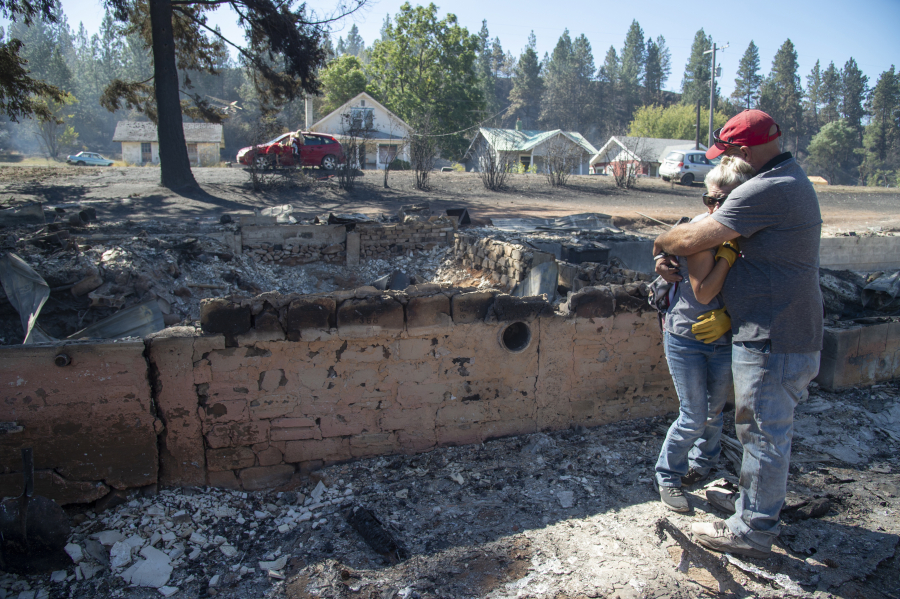 Shawn Thornton hugs his wife, Shannon Thornton, next to the rubble of their burned home Tuesday, Sept. 8, 2020, in Malden, Washington the day after a fast-moving wildfire swept through the tiny town west of Rosalia. Shawn and Shannon weren&#039;t home at the time, but their son Cody was and managed to get their dog and a few belongings before leaving just minutes before the flames swept through.