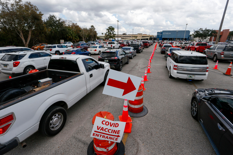 Motorists wait in line to enter a COVID-19 vaccination site at the University Mall parking garage in Tampa on Thursday, Feb. 11, 2021. The traffic was backed up for at least one mile onto Fowler Street.