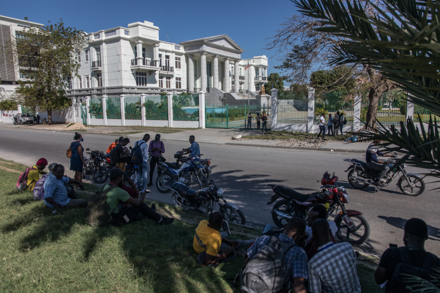 Journalists gather outside the Supreme Court of Haiti (Cours de cassation)on February 8, 2021 in the almost empty streets of Port-au-Prince. - Haitian opposition parties named a top judge as interim leader overnight on February 7, 2021, the latest attempt to oust President Jovenel Moise, whose term they say has expired.