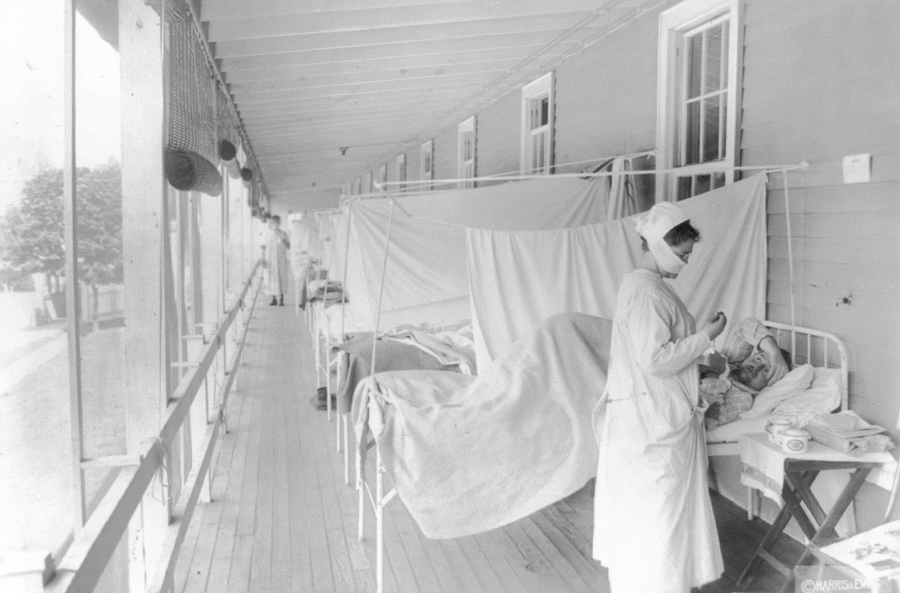 A nurse takes the pulse of a patient in the influenza ward of the Walter Reed hospital in Washington in November 1918. According to the Centers for Disease Control and Prevention, the number of U.S. deaths from the Spanish flu pandemic was estimated to be about 675,000.