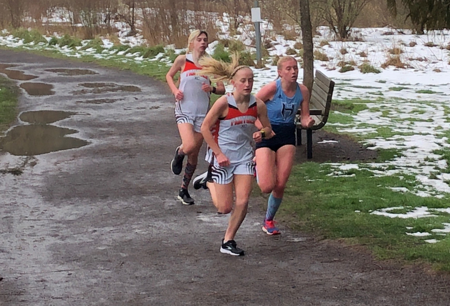 Washougal freshman Elle Thomas runs ahead of Hockinson senior Allyson Peterson and Washougal sophomore Sydnee Boothby during a 5,000 meter race Thursday at Hockinson Meadows Community Park. Thomas won in 18 minutes, 57 seconds.