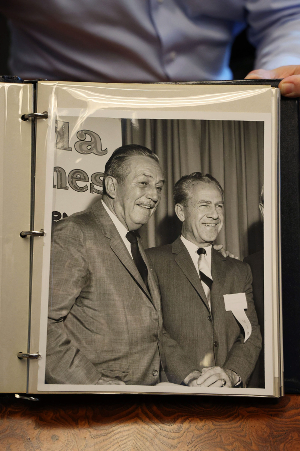 Attorney Kent Hipp shows a photo of Walt Disney and Major General William &quot;Joe&quot; Potter, from a photo album.