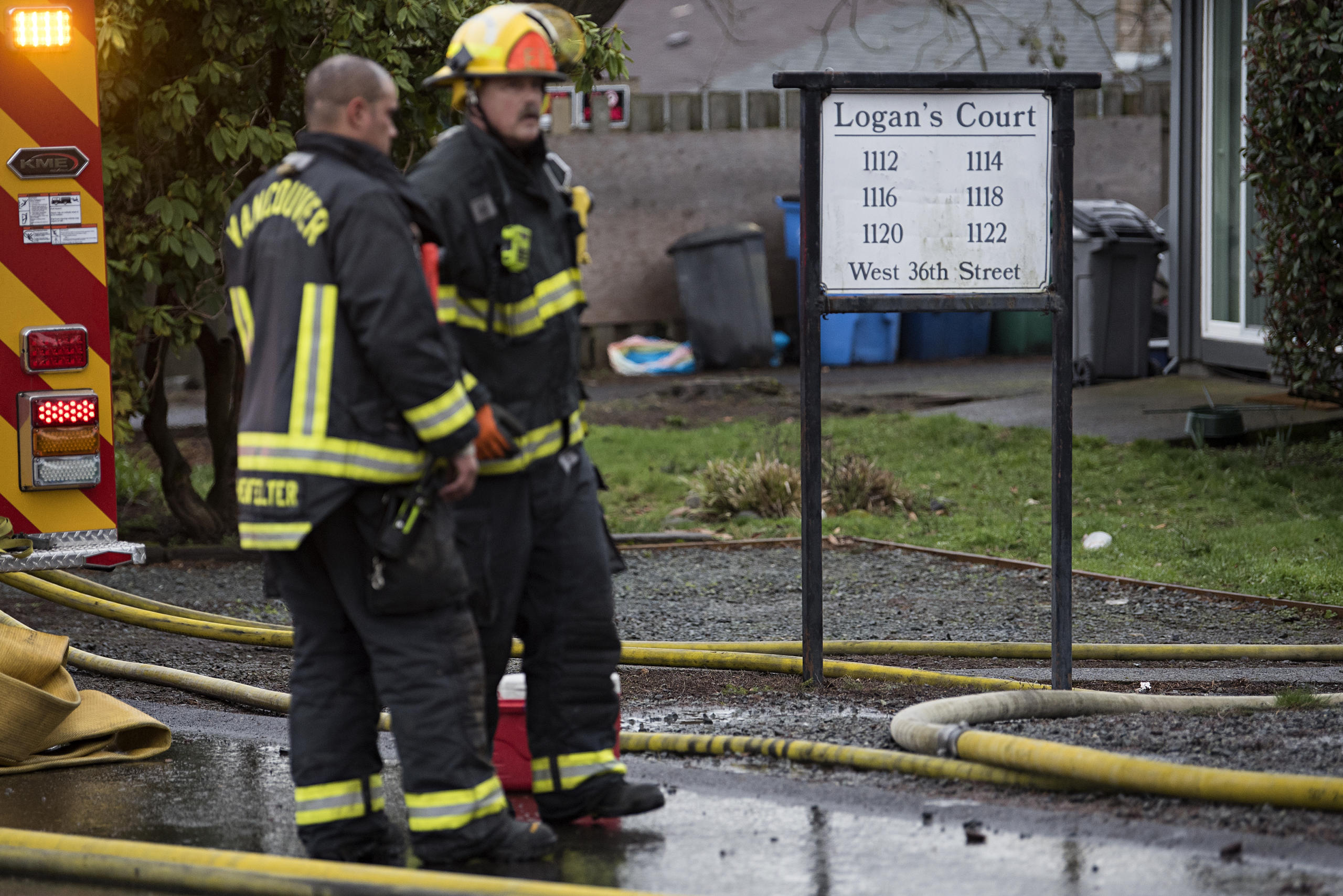 Firefighters work at the scene of a fire at Logan's Court duplex complex in Vancouver's Lincoln neighborhood on Monday afternoon, Feb. 22, 2021.