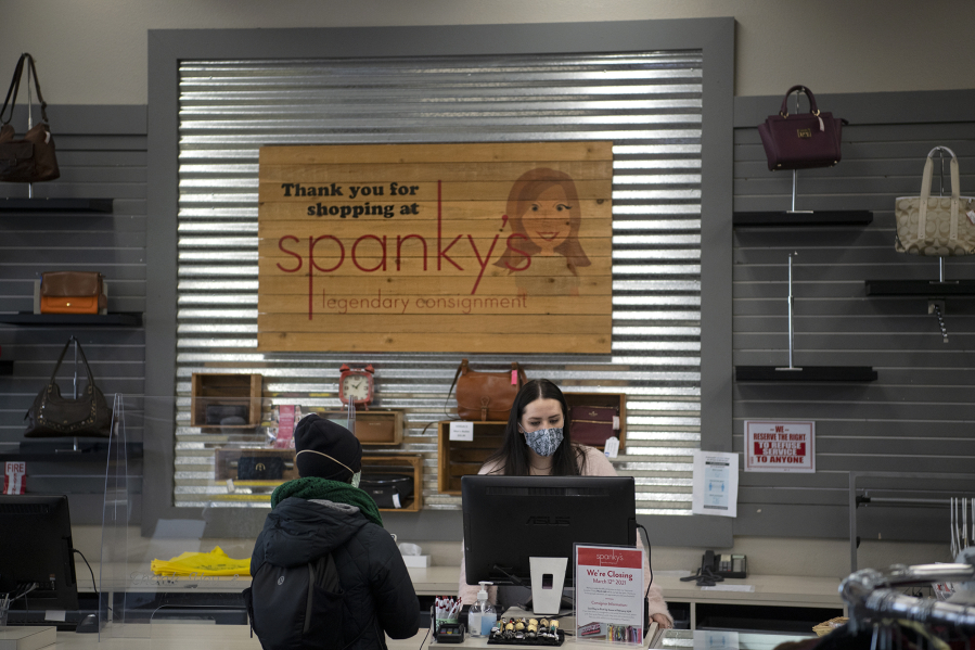 At left, sales associate Rachel Cummings helps a customer on Thursday at Spanky&#039;s. Owner Rachel Phillips bought the store 12 years ago, when it was on Main Street in downtown Vancouver.
