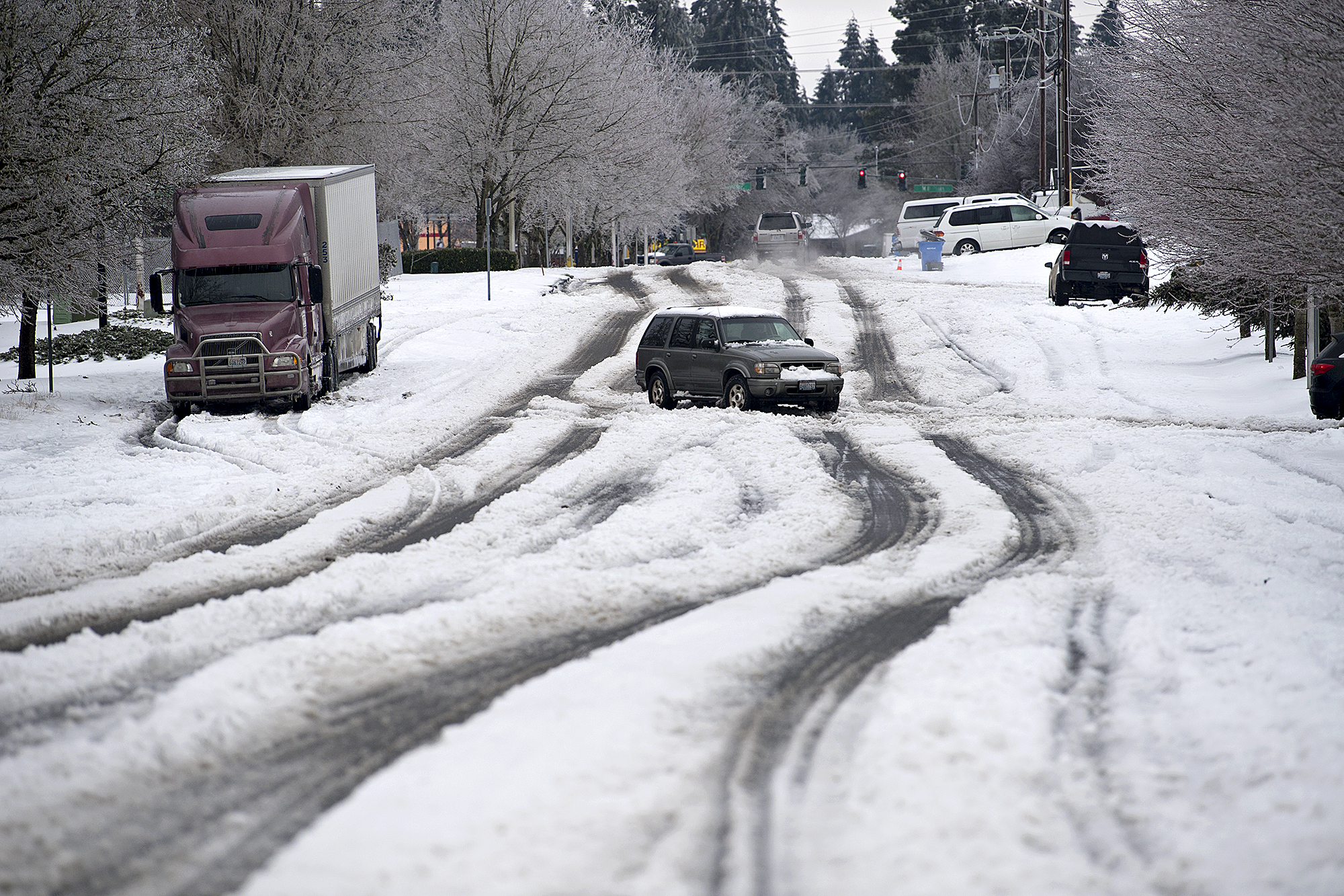 Motorists navigate roads with sketchy winter conditions including snow and ice Monday morning, Feb. 15, 2021.
