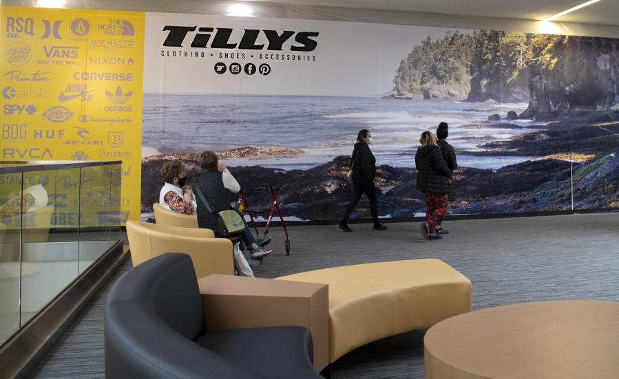 Shoppers rest on recently upgraded seating while others walk by in front the future Tillys storefront at the Vancouver Mall. The casual apparel retailer is set to open in the second quarter of this year, and another big-name clothing chain, Windsor, will debut in the third quarter.