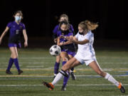 Columbia River’s Andie Buckley passes it past the defense of Hockinson’s Payton Lawson on Saturday, February 27, 2021, at Columbia River High School. The Hawks earned a 1-0 victory over Columbia River in a rematch of the 2019 2A State girls soccer championship.