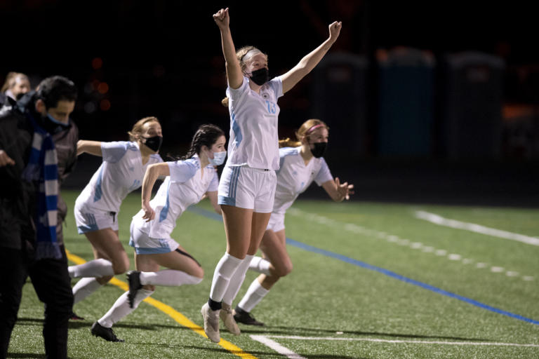 Hockinson’s Grace Abbott raises her arms in celebration as teammates run on the field in victory on Saturday, February 27, 2021, at Columbia River High School. The Hawks earned a 1-0 victory over Columbia River in a rematch of the 2019 2A State girls soccer championship.