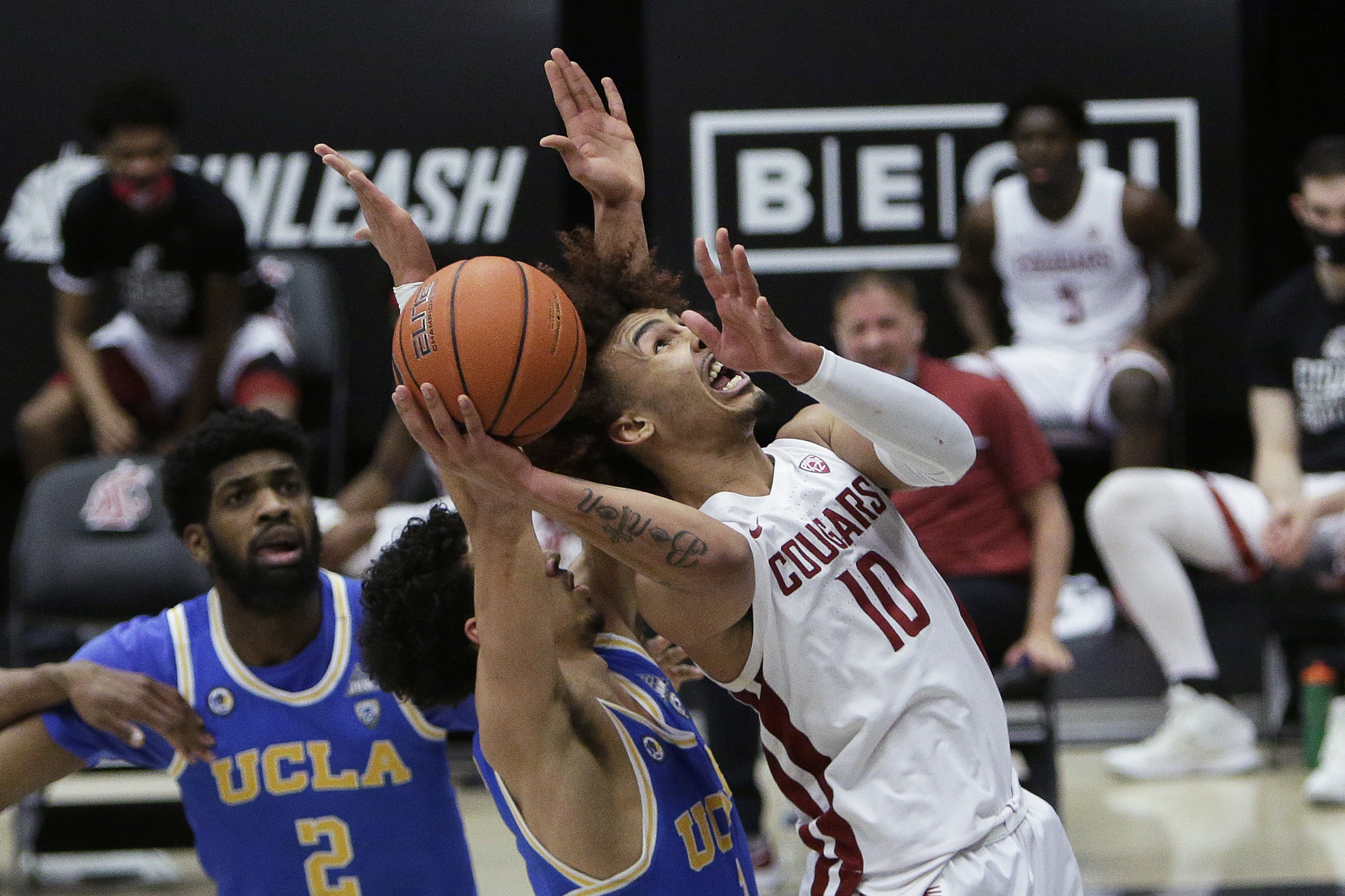 Washington State guard Isaac Bonton, right, shoots while pressured by UCLA guard Jules Bernard during the second half of an NCAA college basketball game in Pullman, Wash., Thursday, Feb. 11, 2021. Washington State won 81-73.