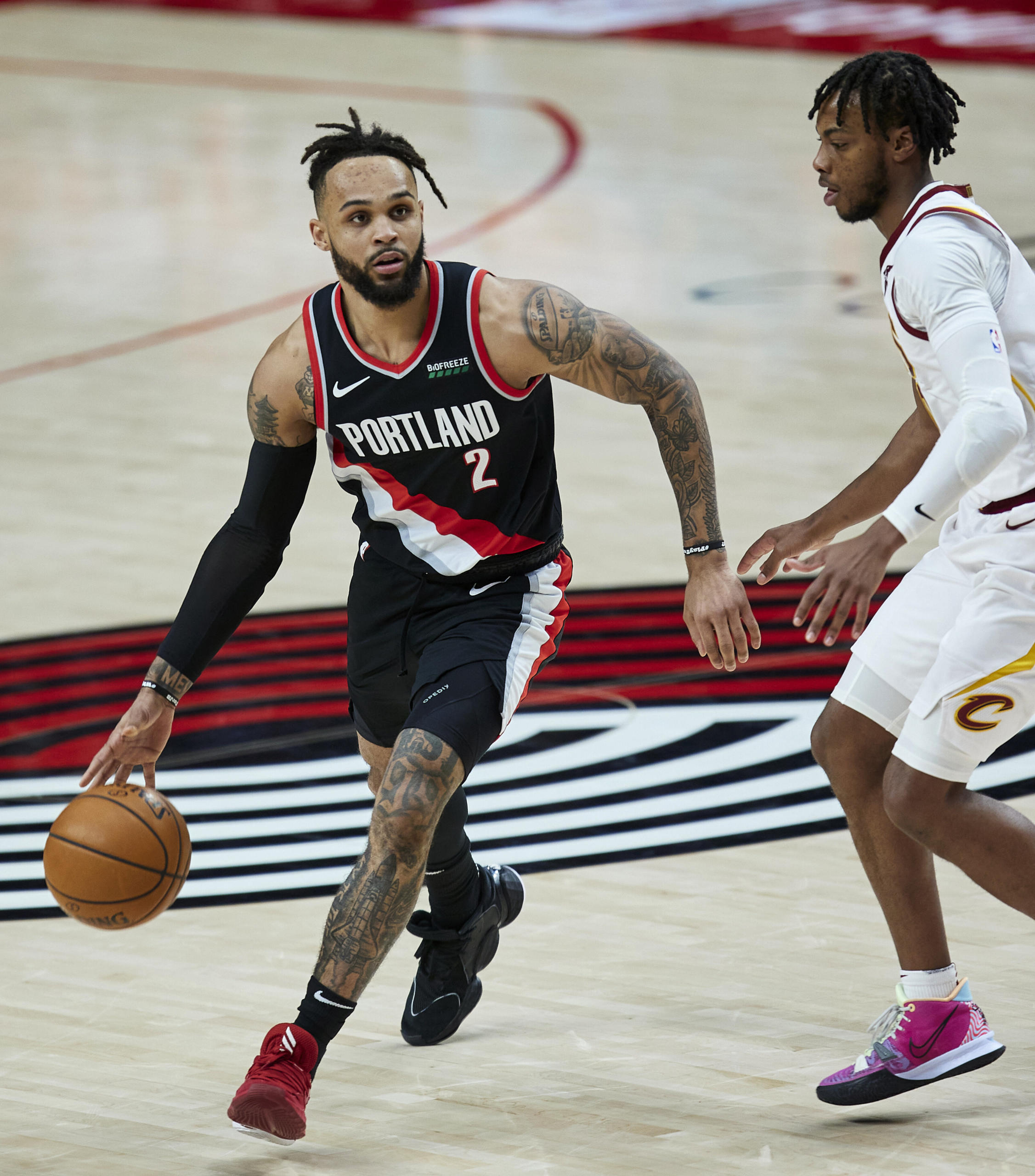 Portland Trail Blazers guard Gary Trent Jr., left, works around Cleveland Cavaliers guard Darius Garland during the second half of an NBA basketball game in Portland, Ore., Friday, Feb. 12, 2021.