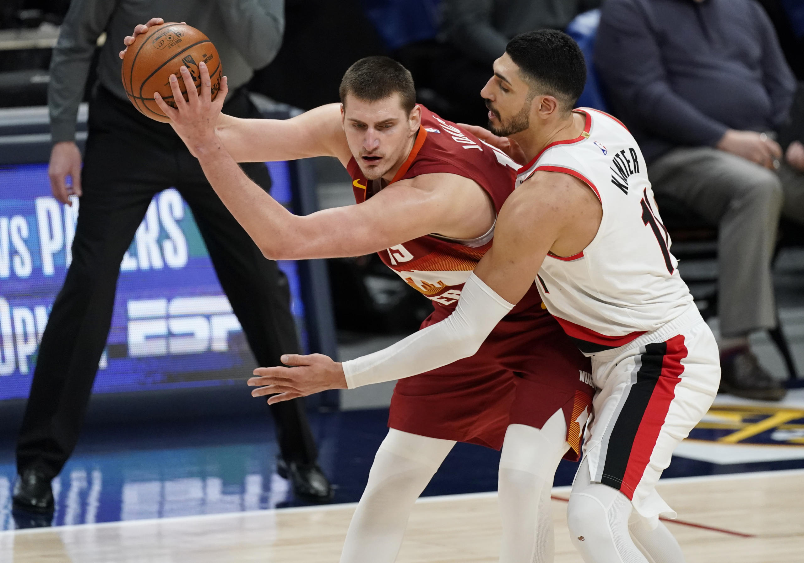 Denver Nuggets center Nikola Jokic, left, is defended by Portland Trail Blazers center Enes Kanter during the second half of an NBA basketball game on Tuesday, Feb. 23, 2021, in Denver.
