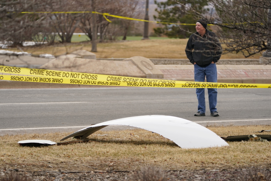 A piece of debris from a commercial airplane is surrounded by police tape on a strip along Midway Boulevard in Broomfield, Colo., after the plane shed parts while making an emergency landing at nearby Denver International Airport Saturday, Feb. 20, 2021.