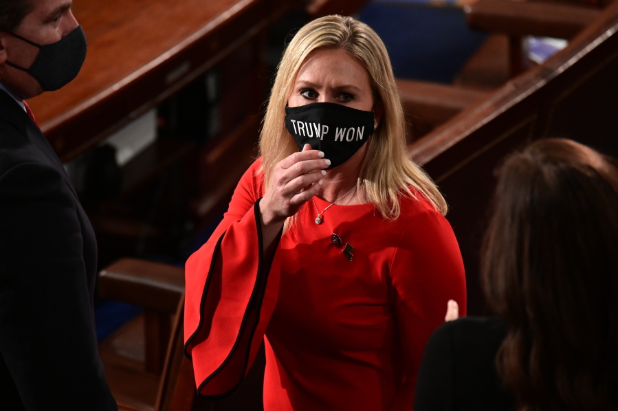 Rep. Marjorie Taylor Greene, R-Ga., wears a &quot;Trump Won&quot; face mask as she arrives on the floor of the House to take her oath of office on opening day of the 117th Congress at the U.S. Capitol in Washington, Sunday, Jan. 3, 2021.