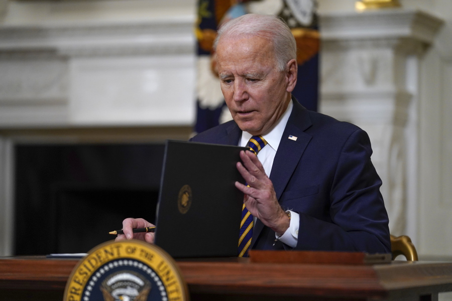 President Joe Biden closes the folder after signing an executive order relating to U.S. supply chains, in the State Dining Room of the White House, Wednesday, Feb. 24, 2021, in Washington.