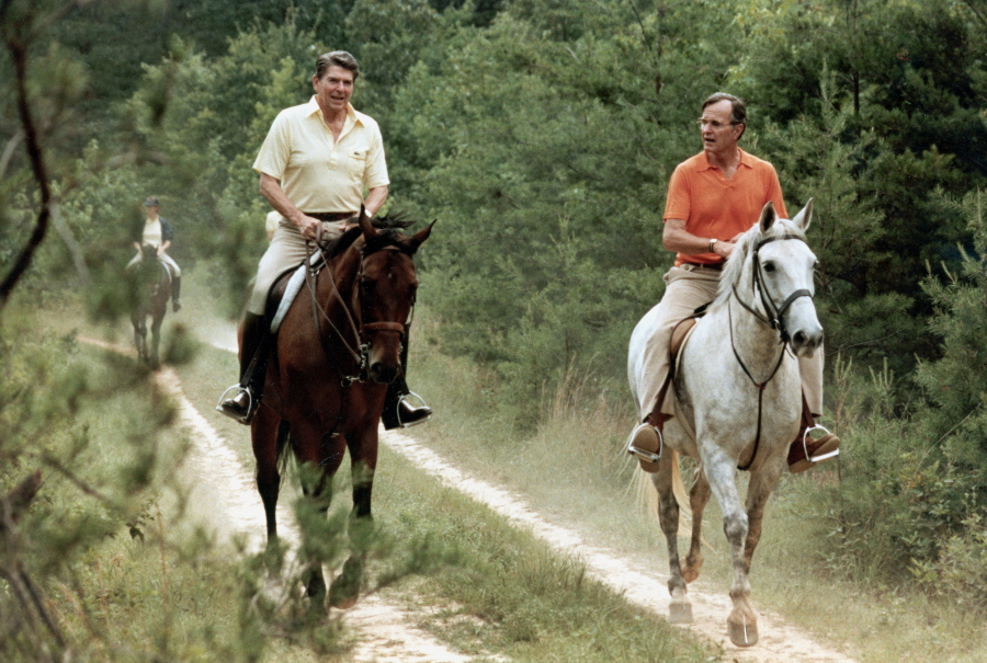 FILE - In this July 1981 file photo released by The White House, U.S. President Ronald Reagan, left, and Vice President George Bush go horseback riding at Camp David, Md. The compound in the Maryland mountains just 60 miles from the capital features everything from a bowling alley to an archery range. It&#039;s been used by every president since Franklin Delano Roosevelt first went there in 1943 as a personal hideaway.
