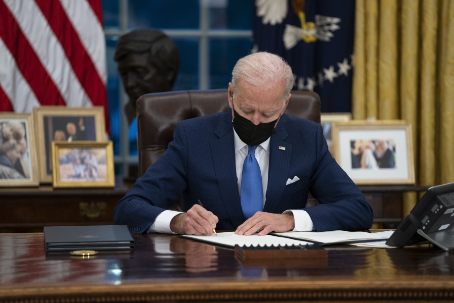 FILE - In this Feb. 2, 2021, file photo, President Joe Biden signs an executive order, in the Oval Office of the White House, in Washington.  Biden is signing an executive order Wednesday to review the United States&#039; supply chains for large capacity batteries, pharmaceuticals, critical minerals and semiconductors.